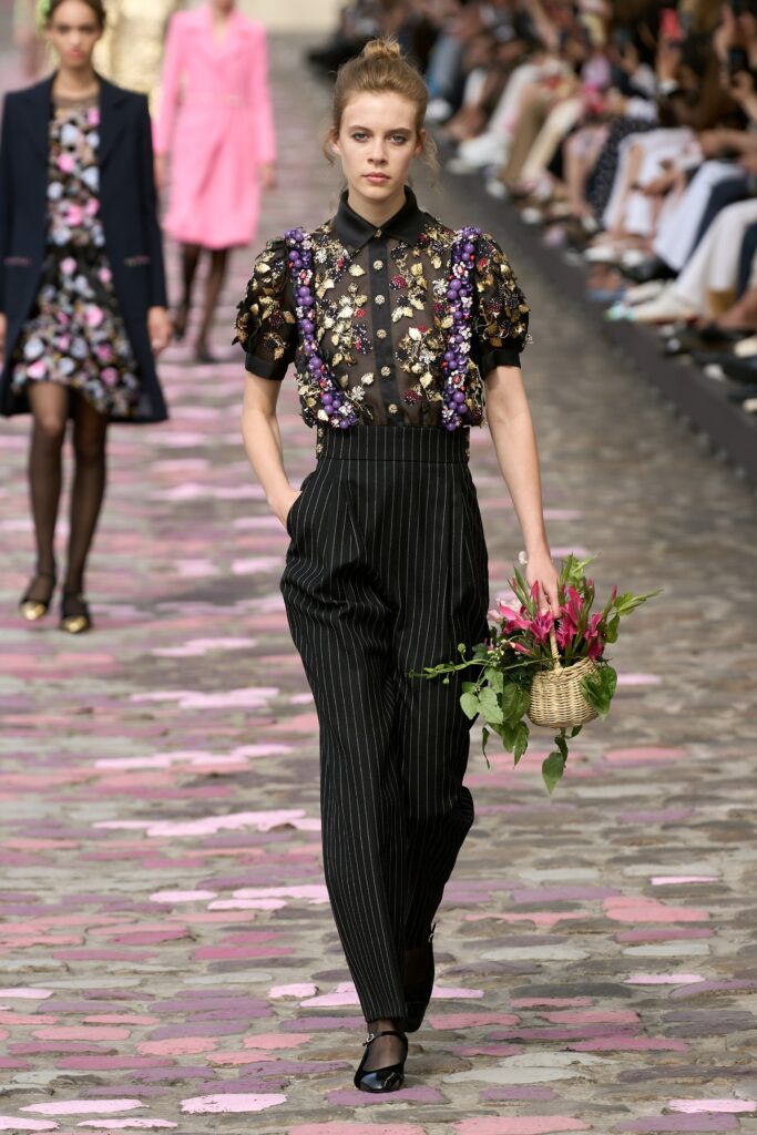 A fitted black striped shirt with floral details paired with matching pants.