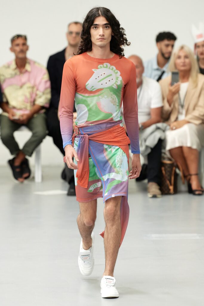 A fitted multicolor dress with long sleeves, a V-neckline, and an asymmetric design.