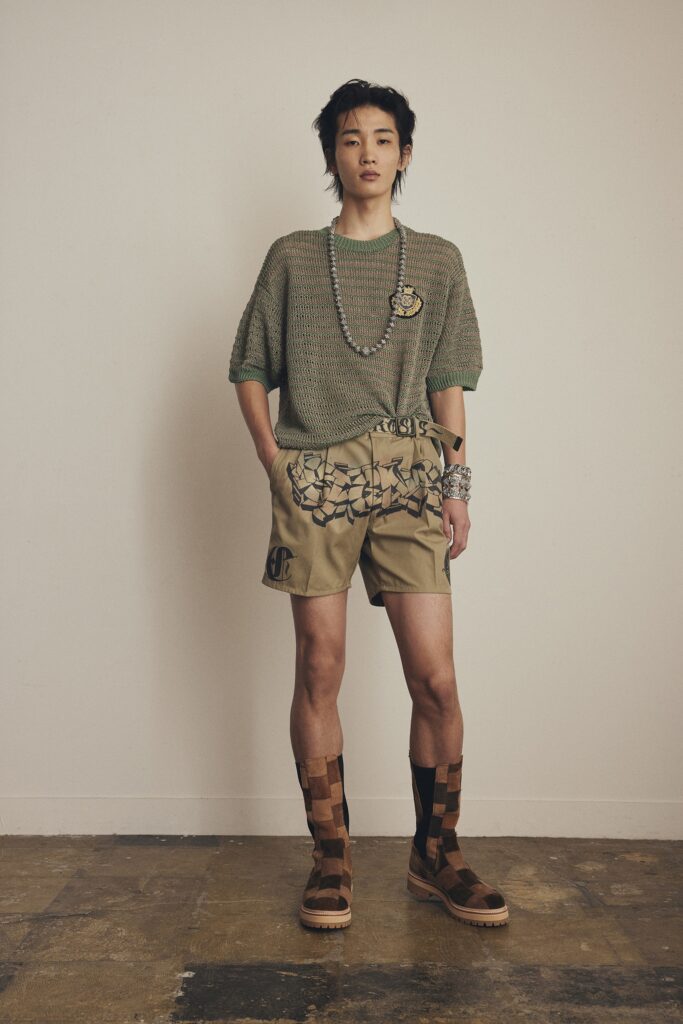 A relaxed green short-sleeve top paired with beige printed shorts.