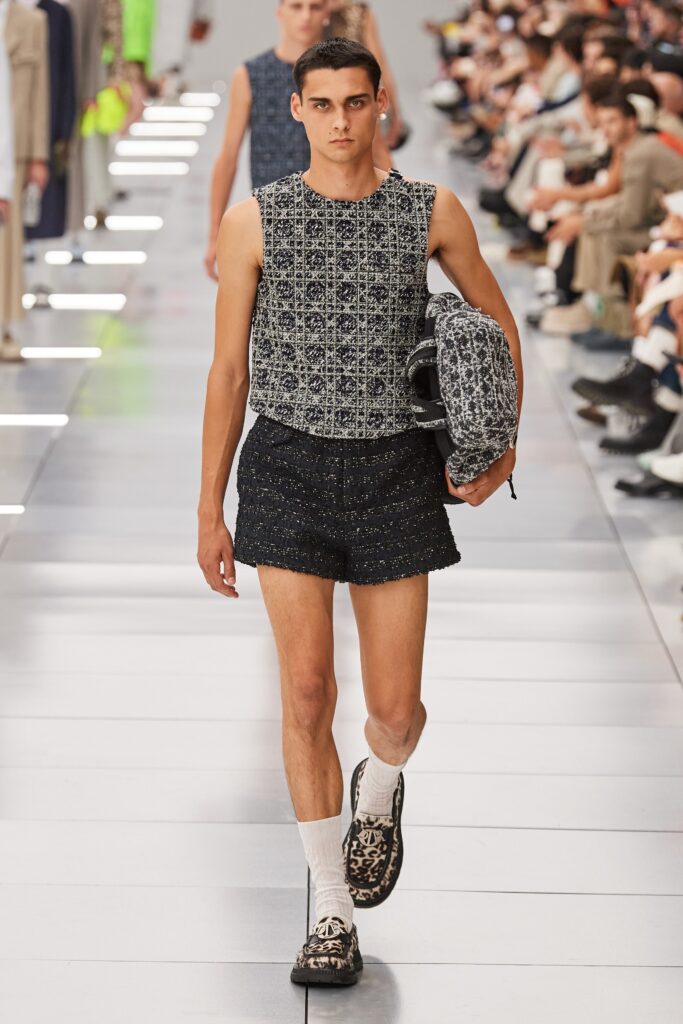 A fitted black and white printed sleeveless top paired with black shorts.