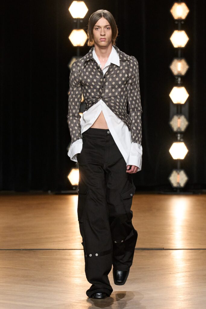A relaxed-fit printed shirt with a collared neckline paired with black pants.
