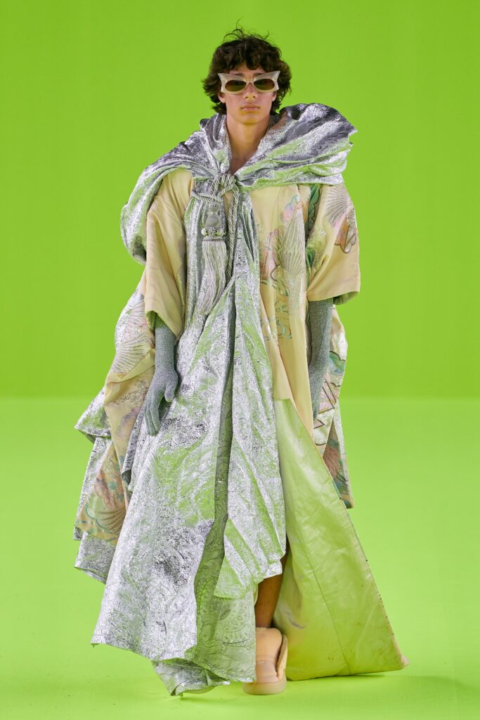 A relaxed silver silk layered cape dress with a V-neckline.