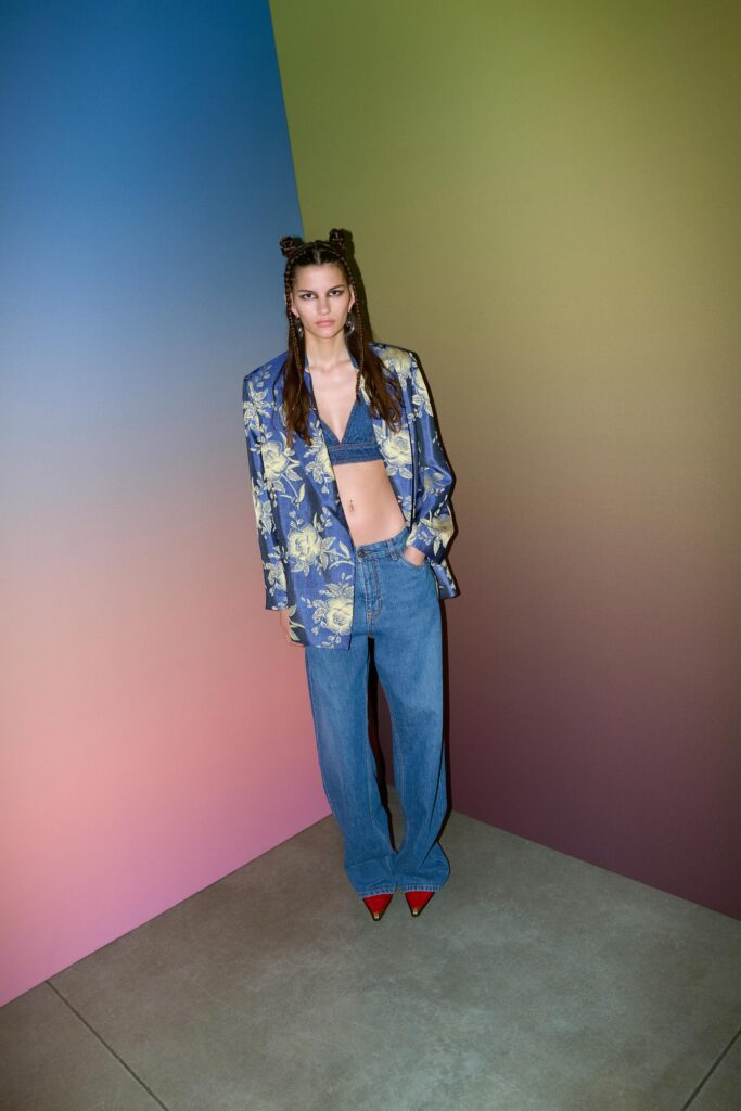 A relaxed blue printed jacket paired with wide-leg denim pants for a stylish look.