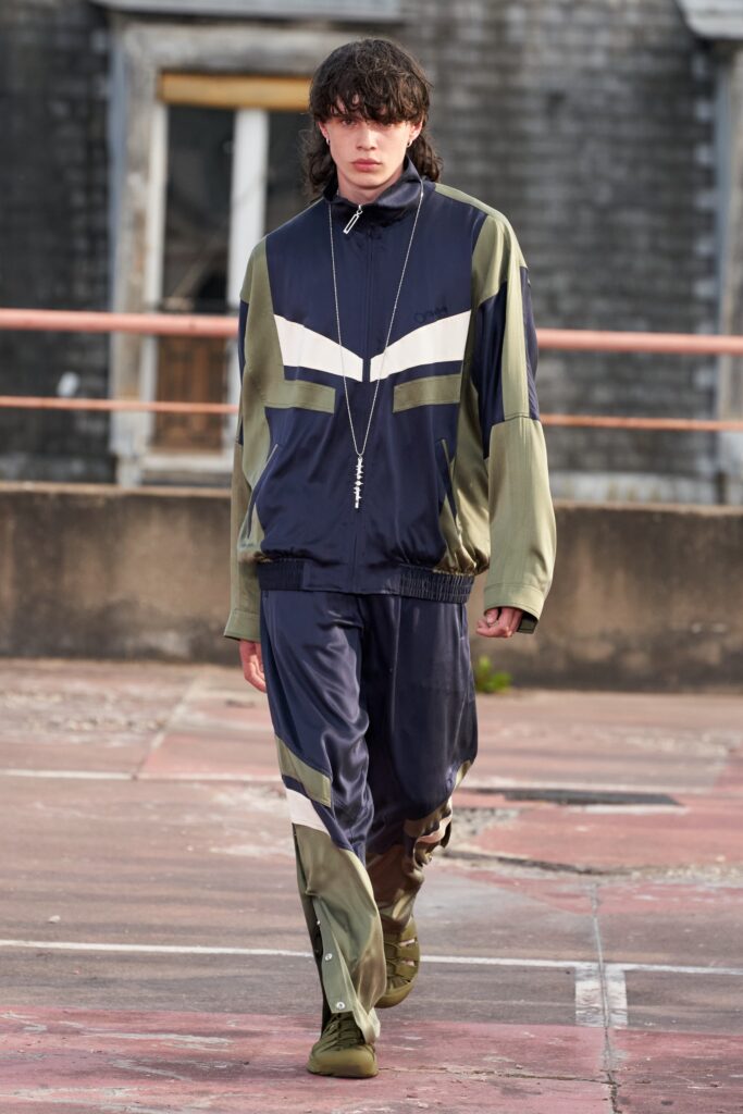 A relaxed-fit navy and green color-blocked jacket paired with matching pants.
