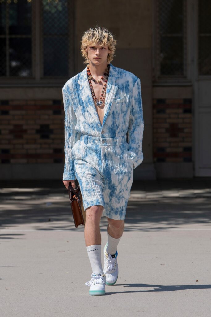 A relaxed blue printed jumpsuit with a V-neckline and short sleeves.