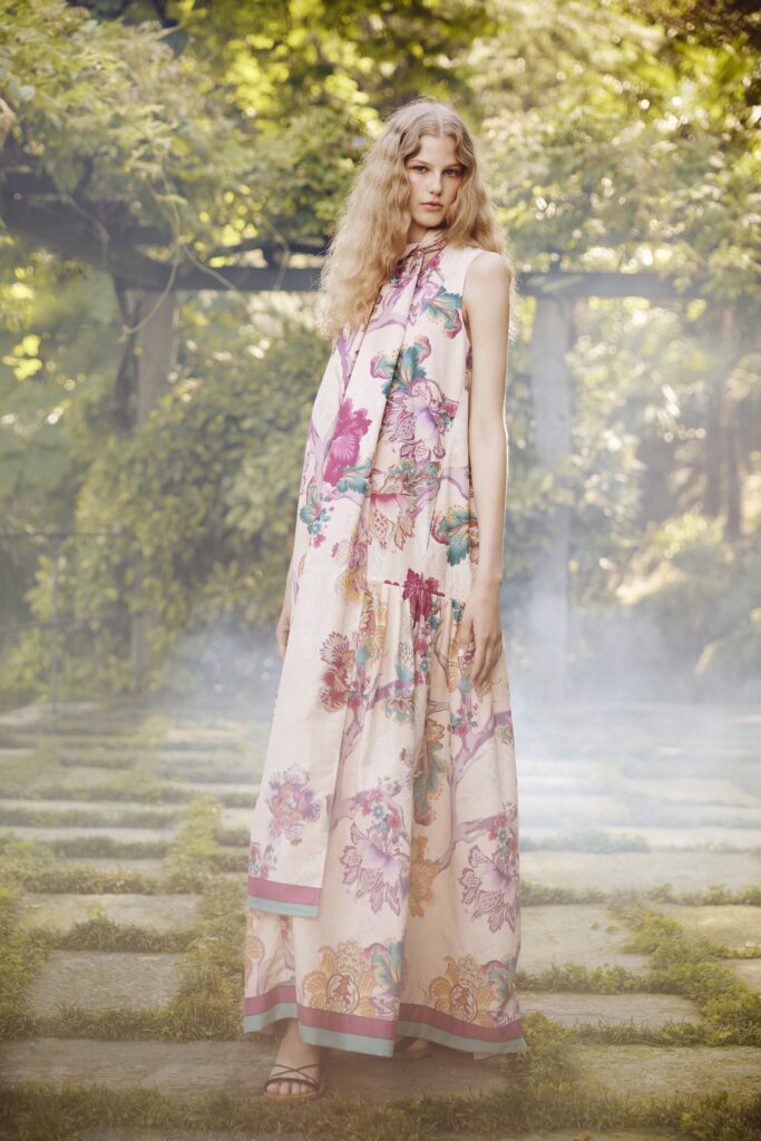 A relaxed pink cotton sleeveless dress with a V-neckline and tiered design.