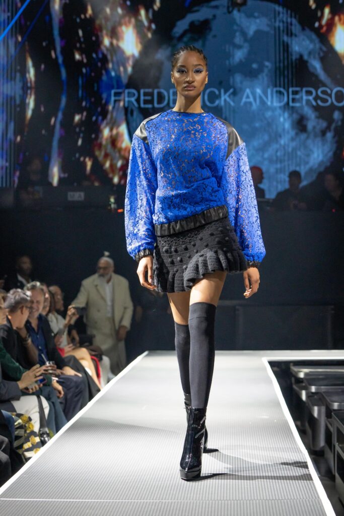 A fitted blue lace long-sleeve top paired with a layered ruffled black skirt.