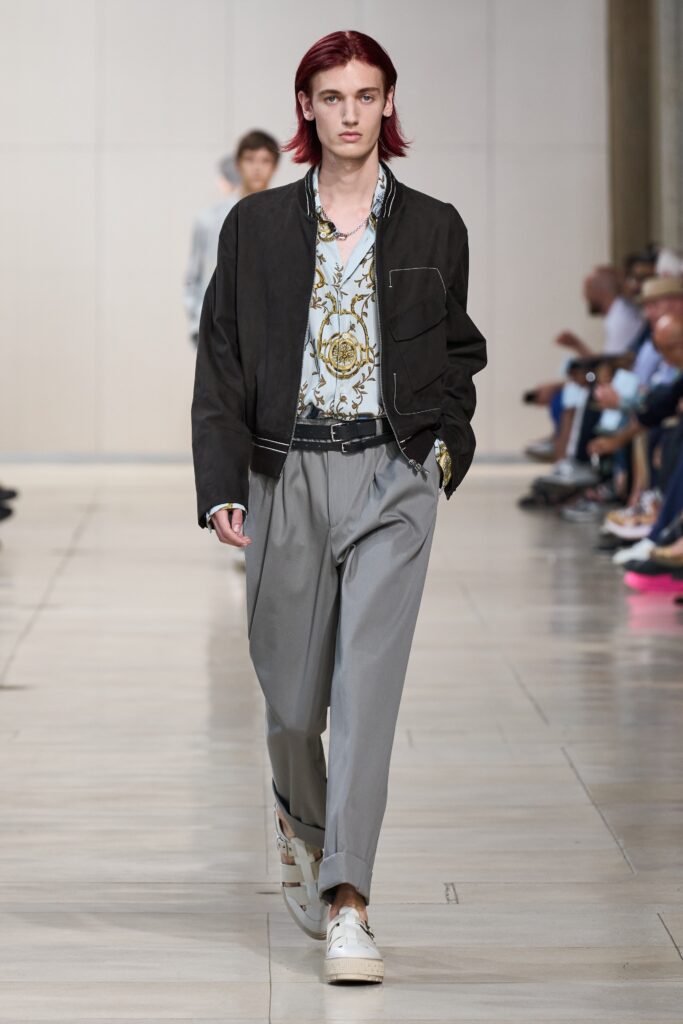 A relaxed black jacket paired with gray pants featuring a collared shirt underneath.