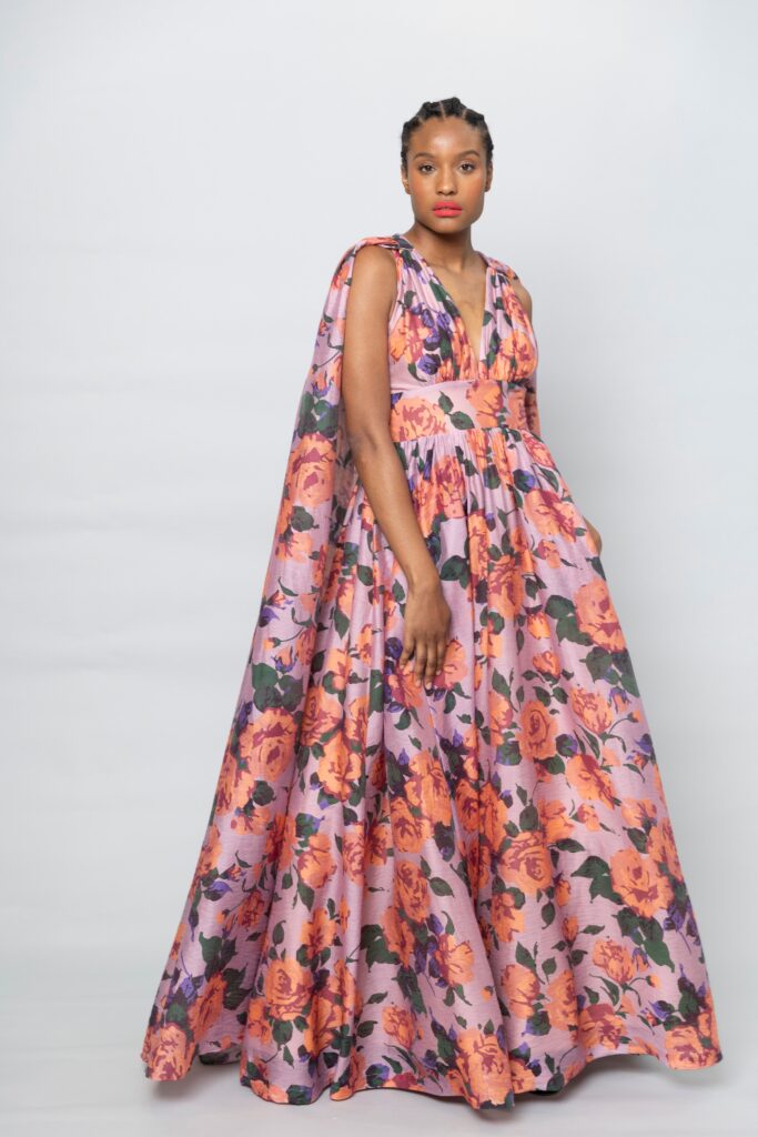 A relaxed purple dress with a V-neckline, floral pattern, and flared silhouette.