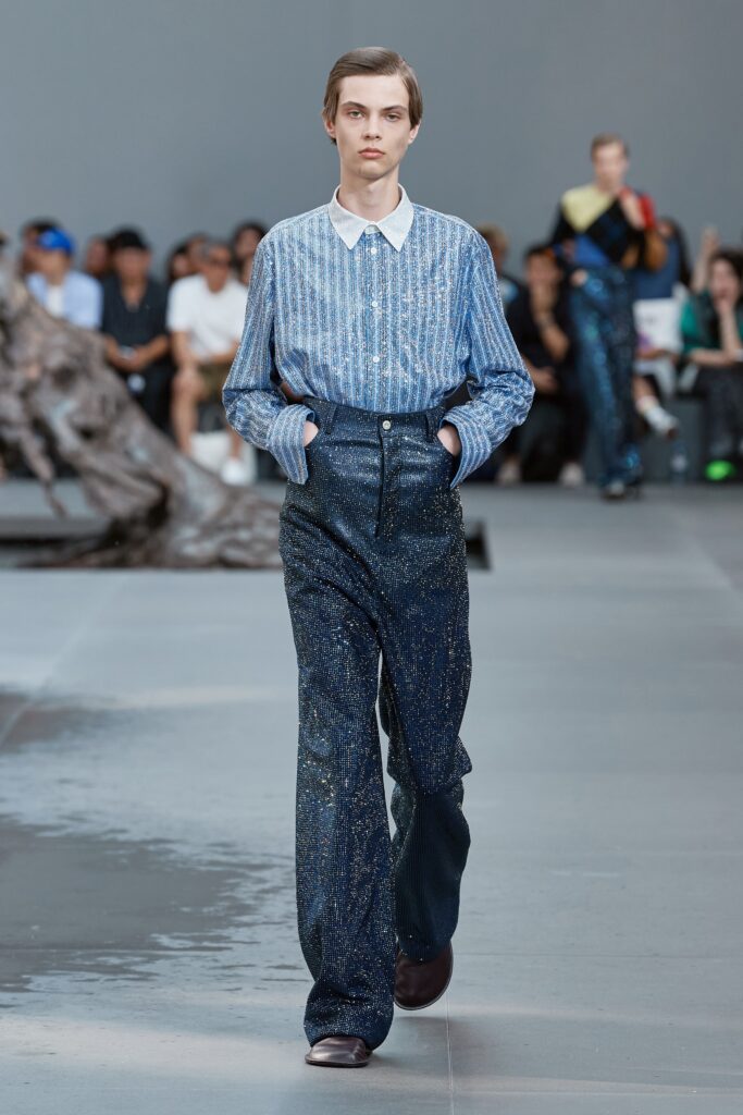 A relaxed blue striped long-sleeve shirt paired with wide-leg gray pants.