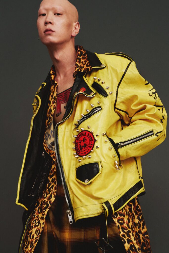 A relaxed yellow leather jacket with long sleeves and printed pants.