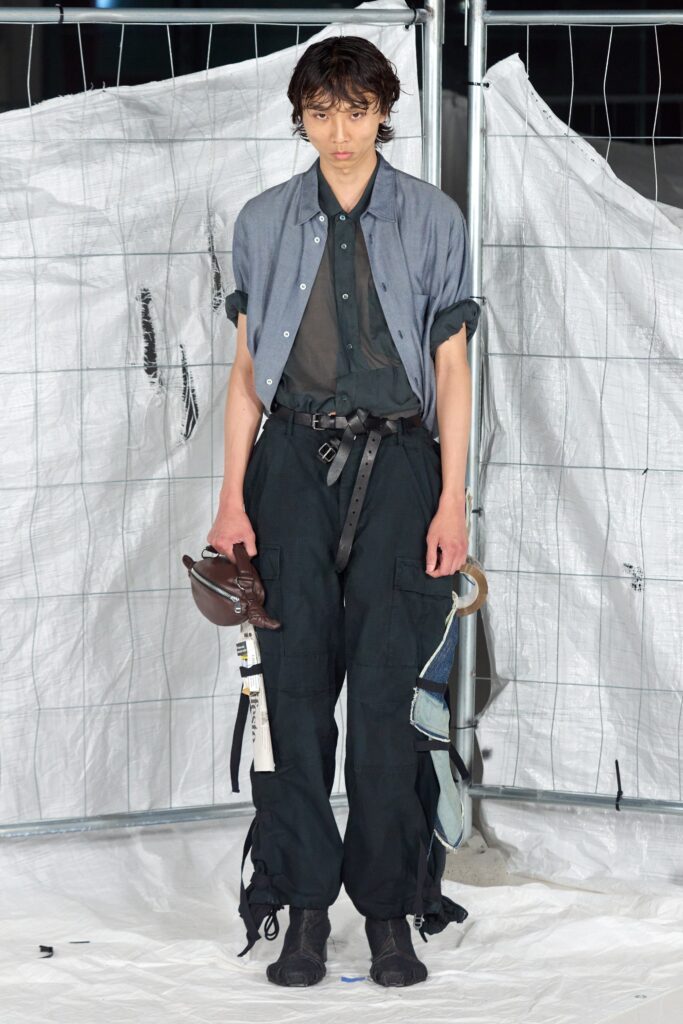 blue collared shirt and black cargo pants