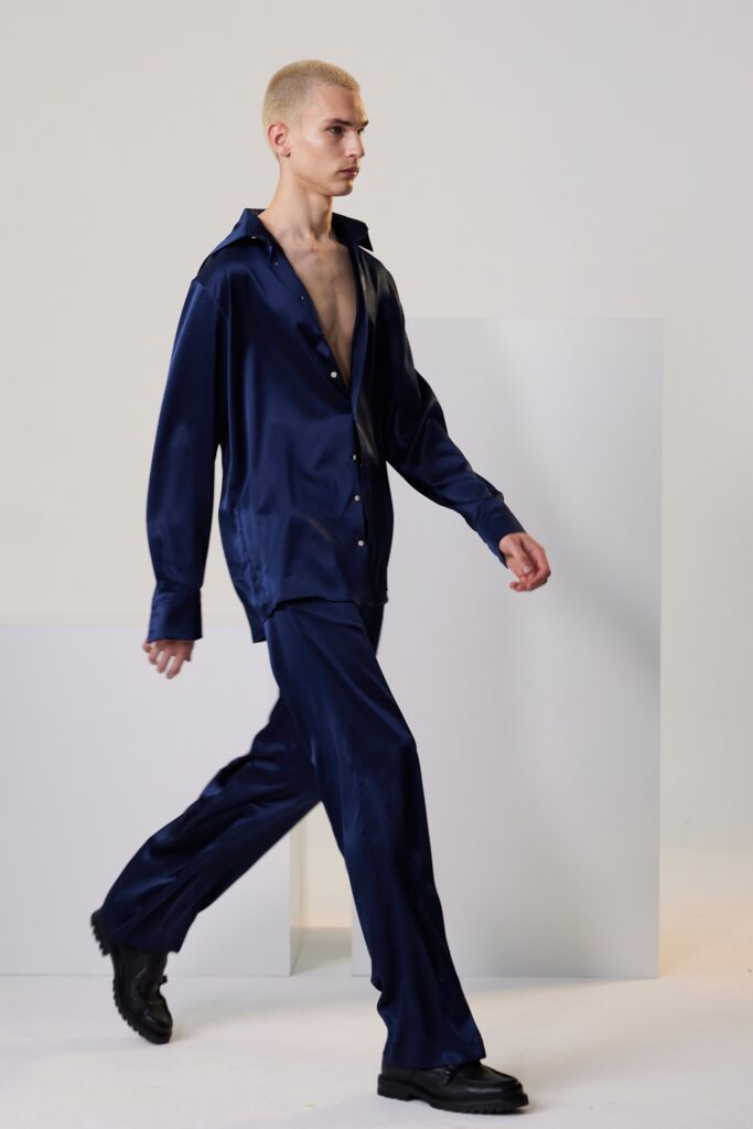 A relaxed blue silk long-sleeve shirt paired with matching pants featuring a buttoned design.