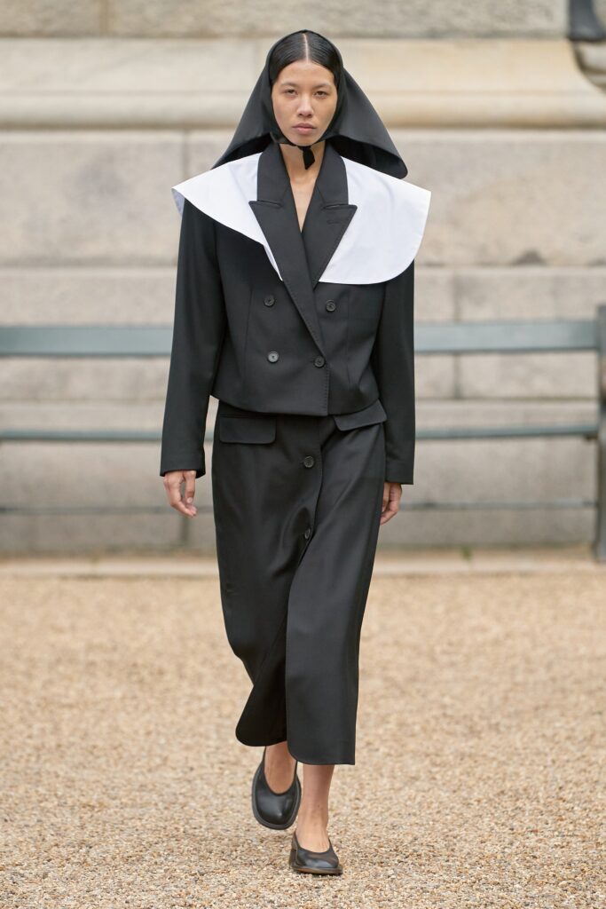 A relaxed black and white jacket with a collared design paired with a matching skirt.