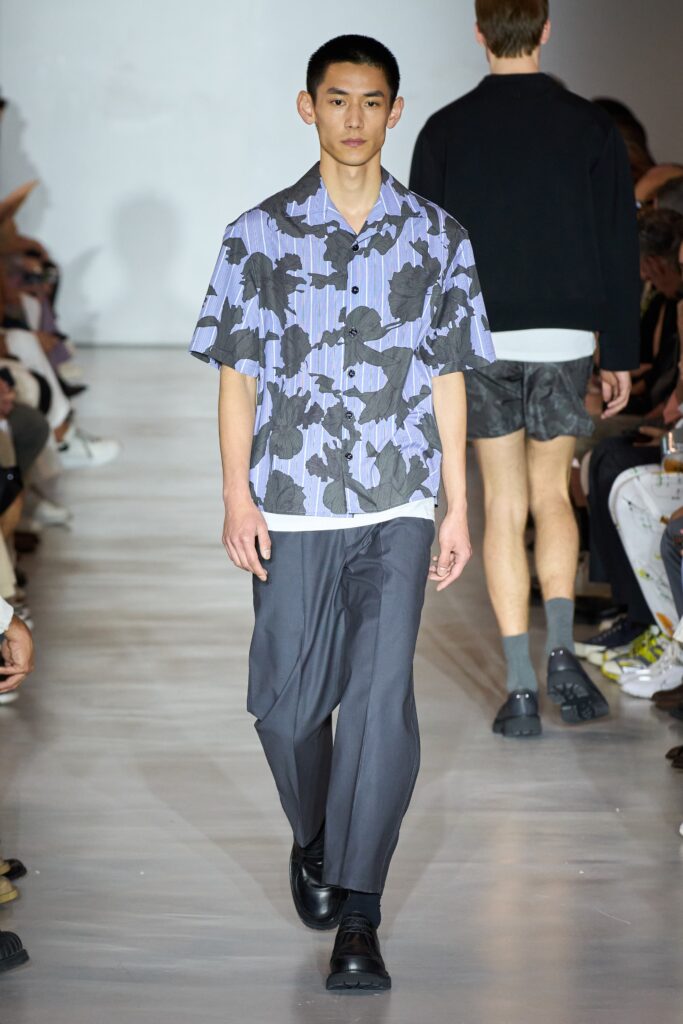 A relaxed blue floral short-sleeve shirt paired with black pants for a modern look.