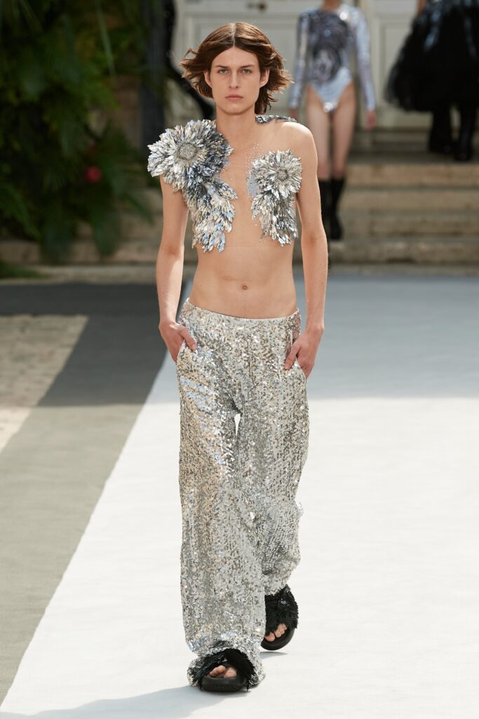 Relaxed silver sequin pants with a wide-leg silhouette, perfect for a bold fashion statement.