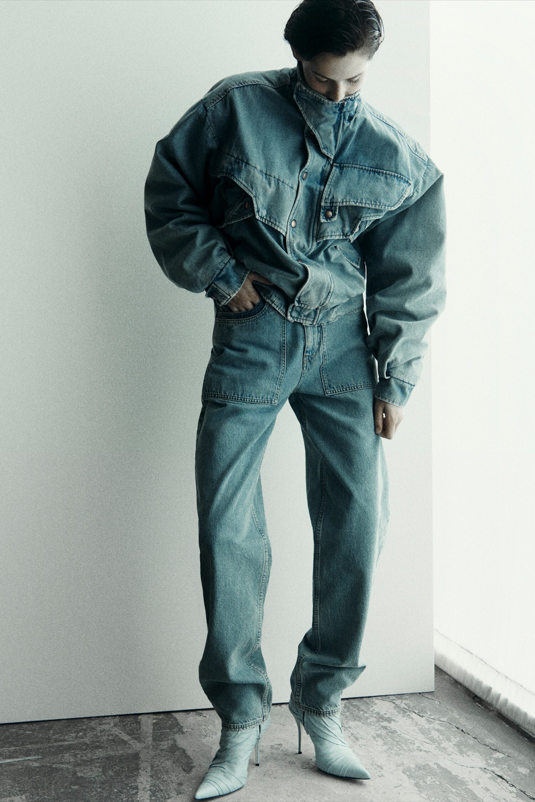 A relaxed blue denim jacket with long sleeves and wide-leg pants, featuring a buttoned design.