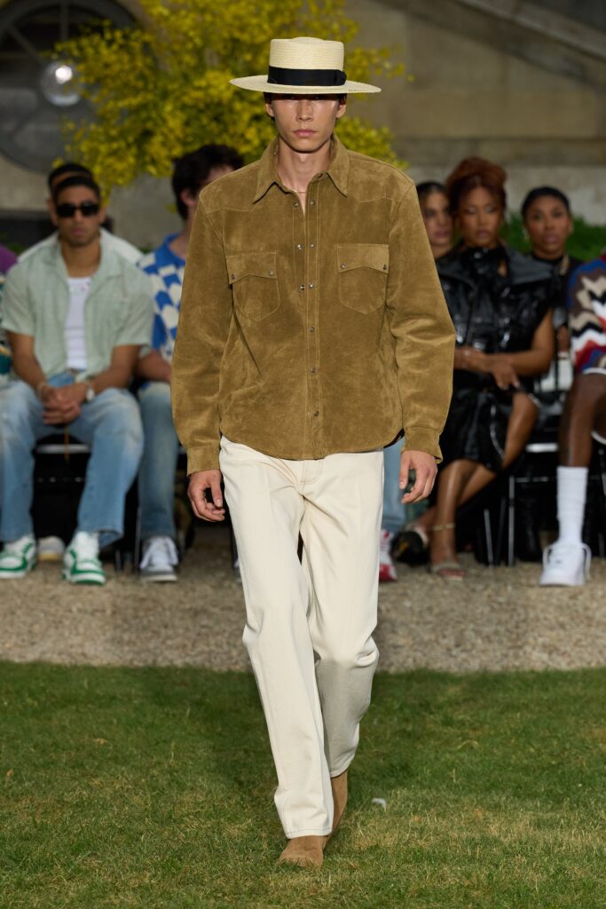 A relaxed brown cotton long-sleeve shirt with a collared design paired with white pants.