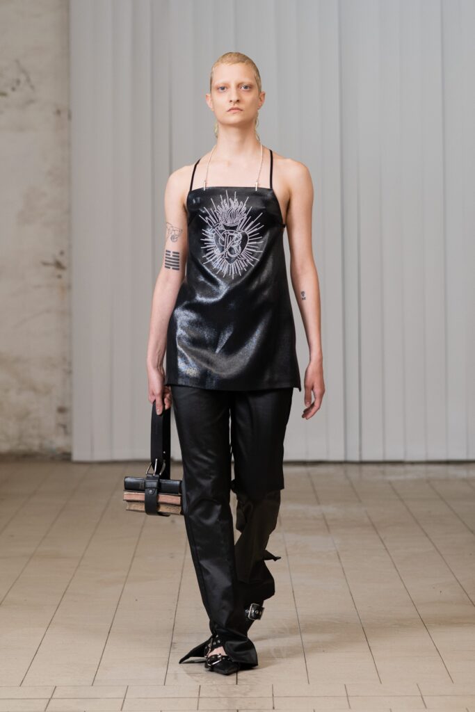 A fitted black leather sleeveless top paired with sleek black leather pants for a chic look.