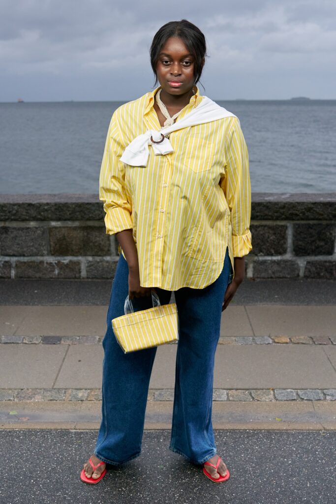 A relaxed yellow striped long-sleeve shirt paired with wide-leg blue pants.