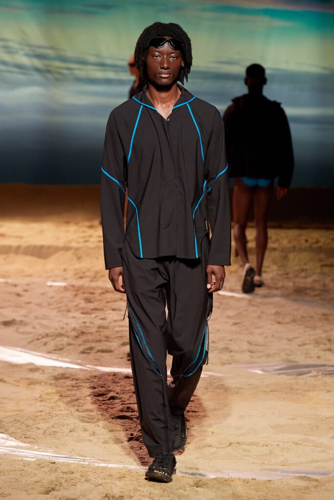 A relaxed black jacket with long sleeves and matching pants featuring a zippered detail.