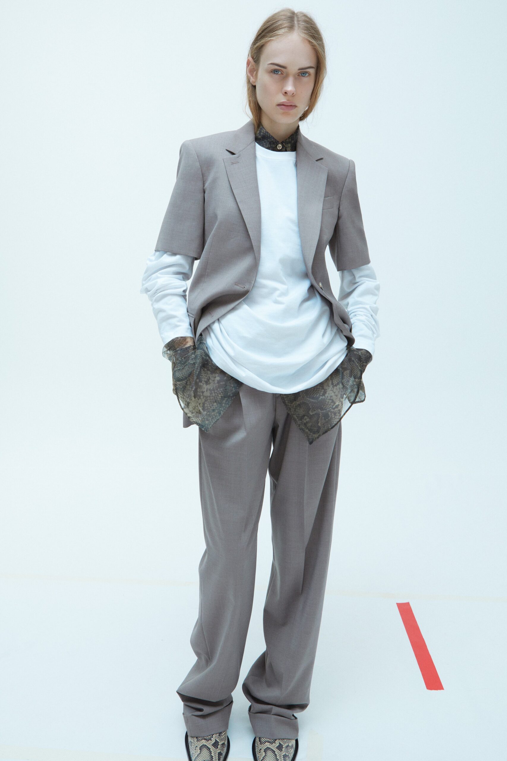 A relaxed gray suit featuring a long-sleeve collared shirt and buttoned details.