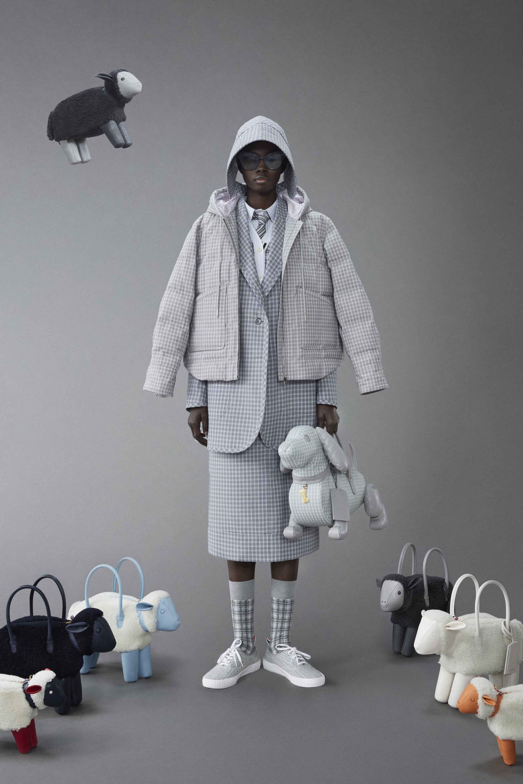 A relaxed gray checked jacket paired with a matching skirt and collared shirt.