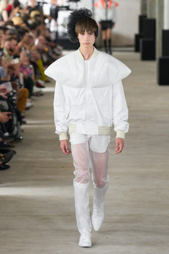 A relaxed white jacket with long sleeves and asymmetric design paired with matching pants.