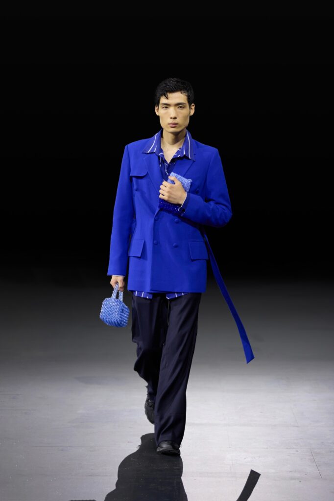An oversized blue jacket paired with loose-fitting pants, creating a stylish and modern look.
