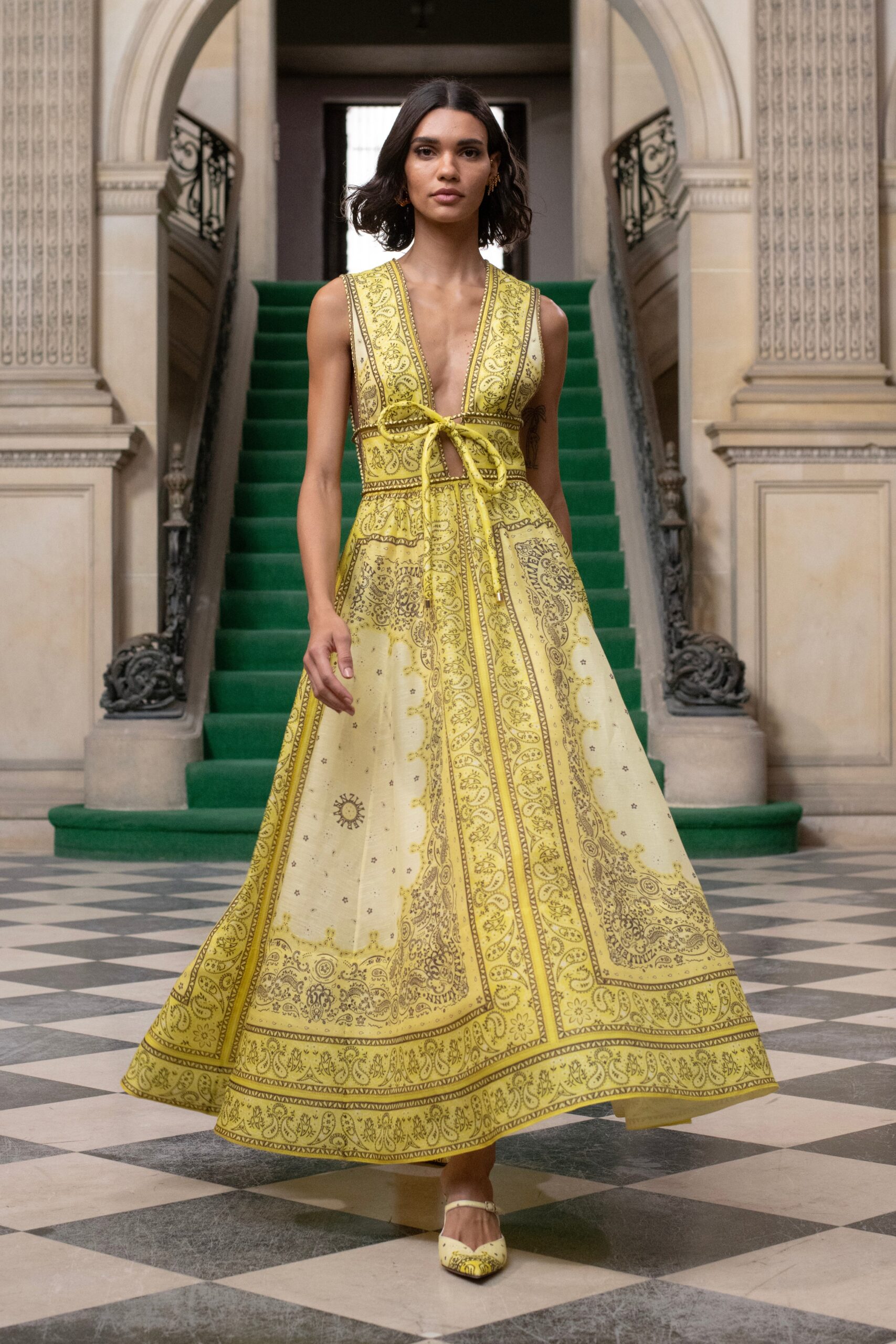 A relaxed yellow silk sleeveless dress with a V-neckline and intricate printed design.