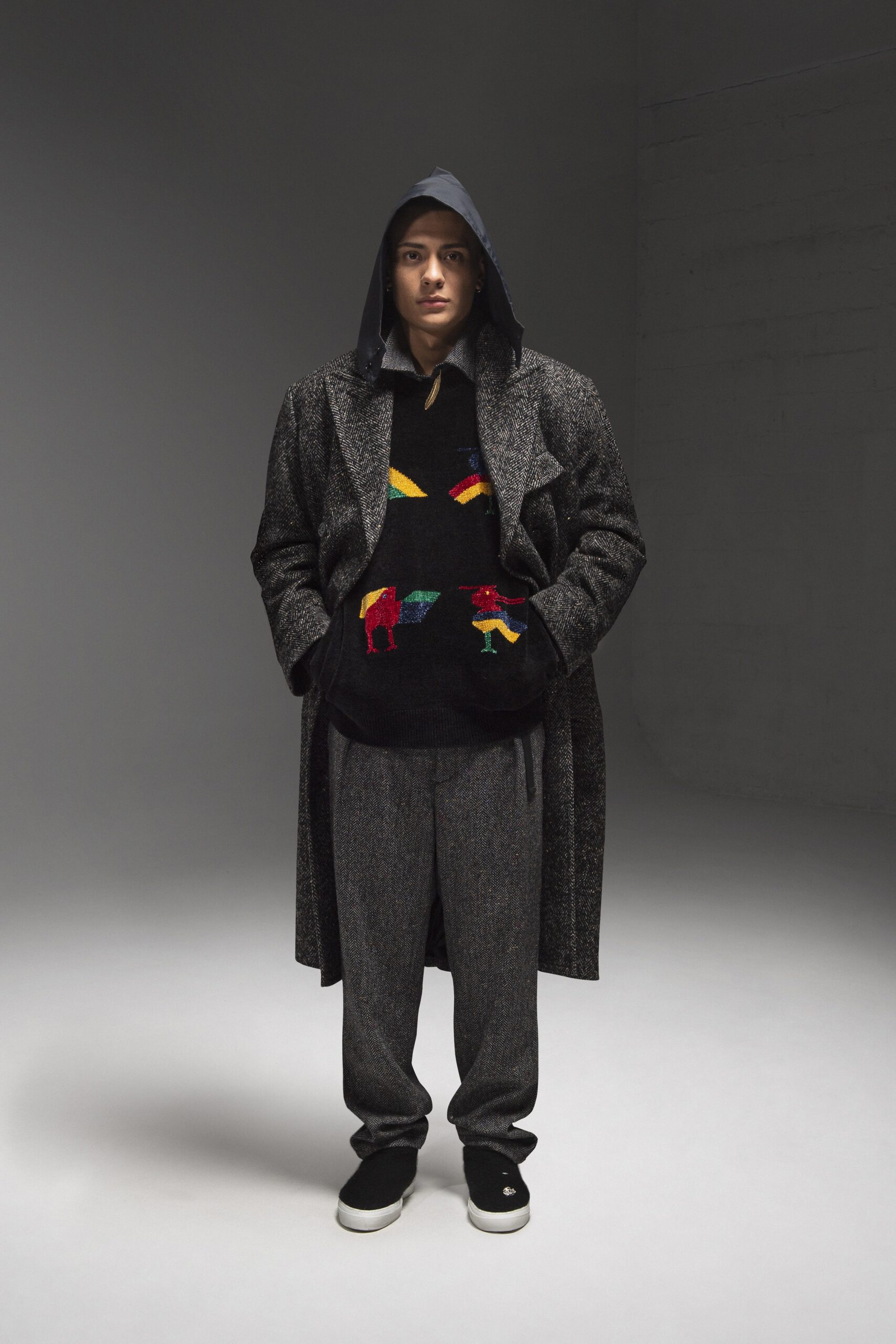 A relaxed gray wool coat with a hood, paired with matching relaxed pants.