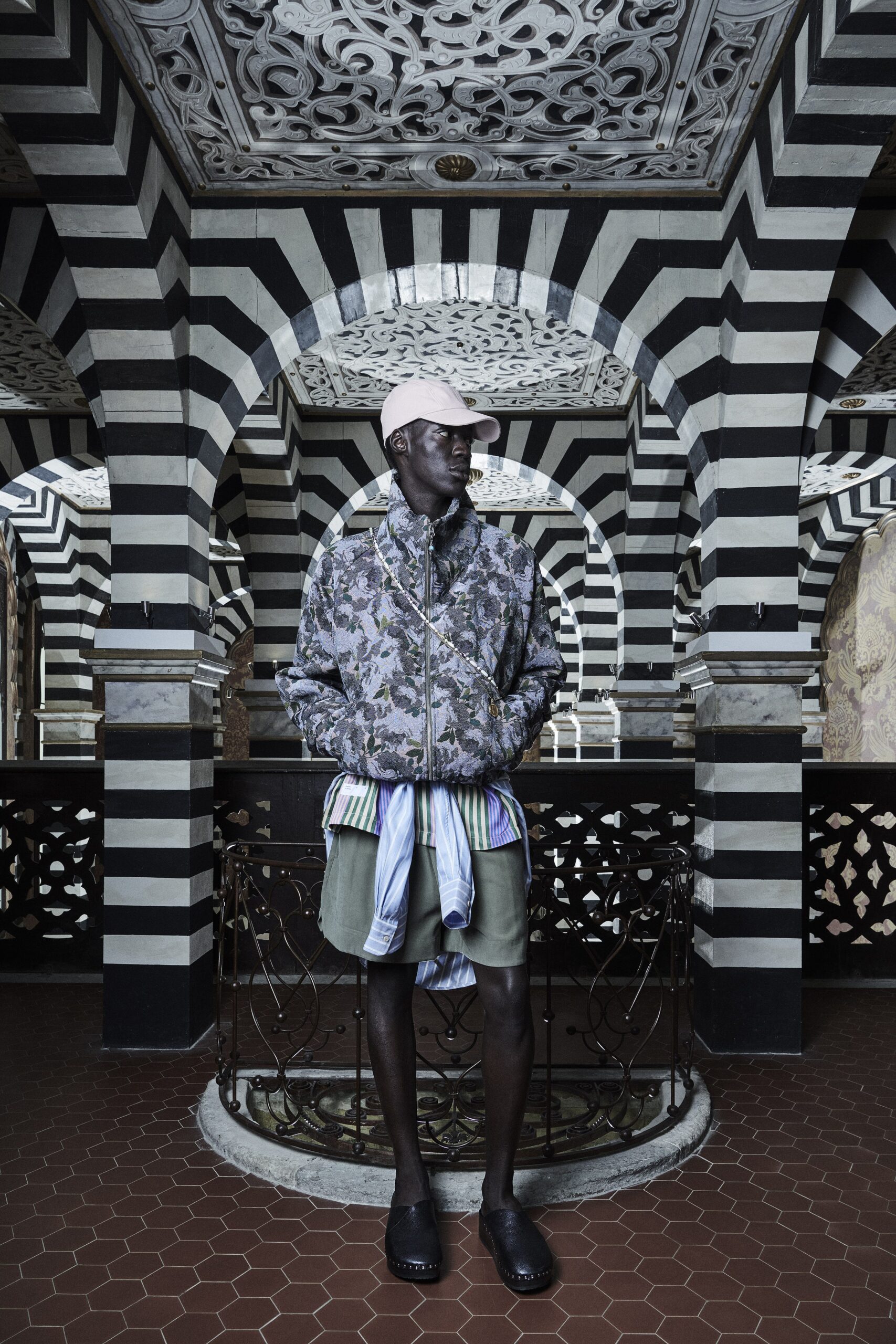 A relaxed multicolor jacket with long sleeves and a collared design, paired with printed shorts.