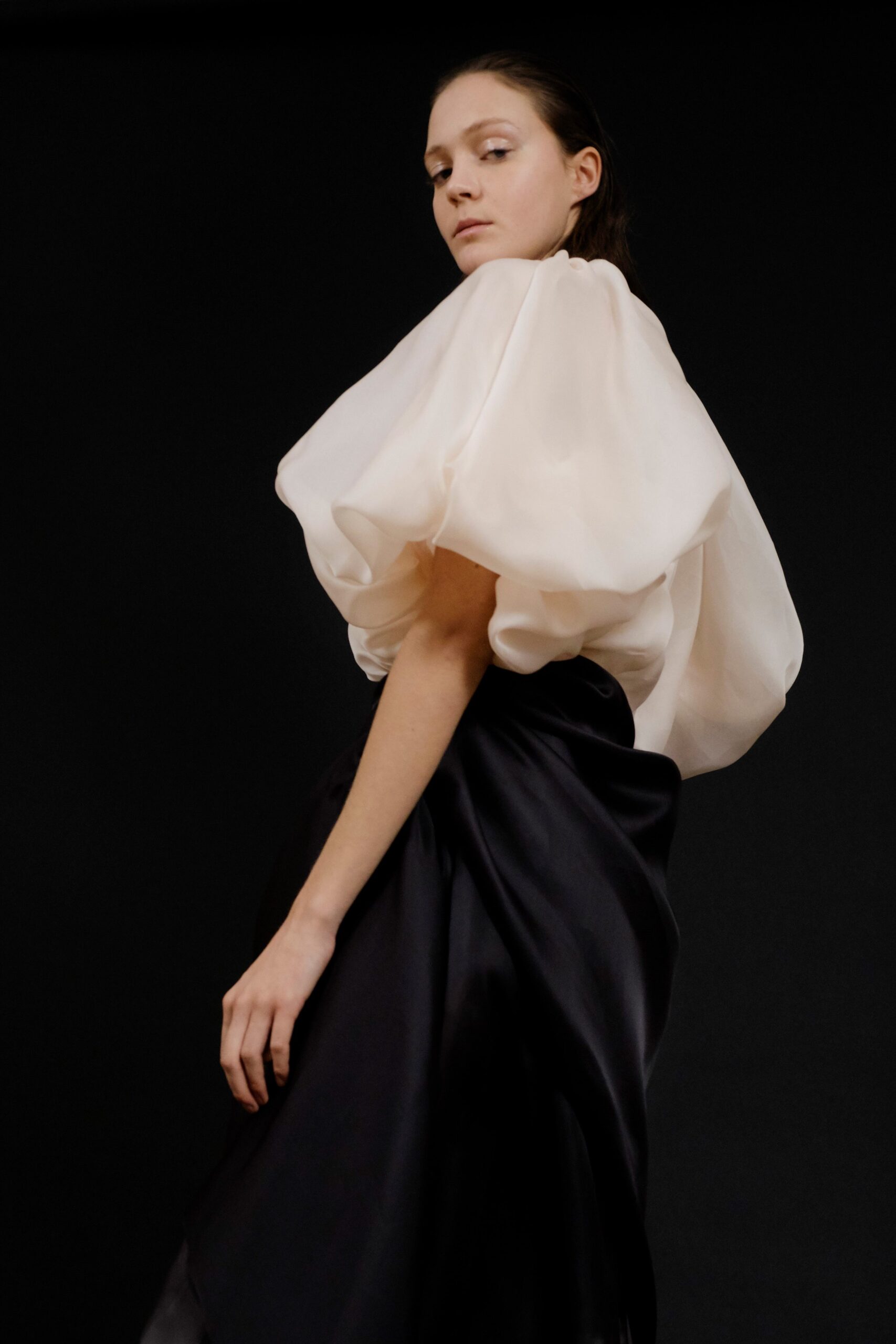 white silk short-sleeve high-neck fitted padded flowing blouse