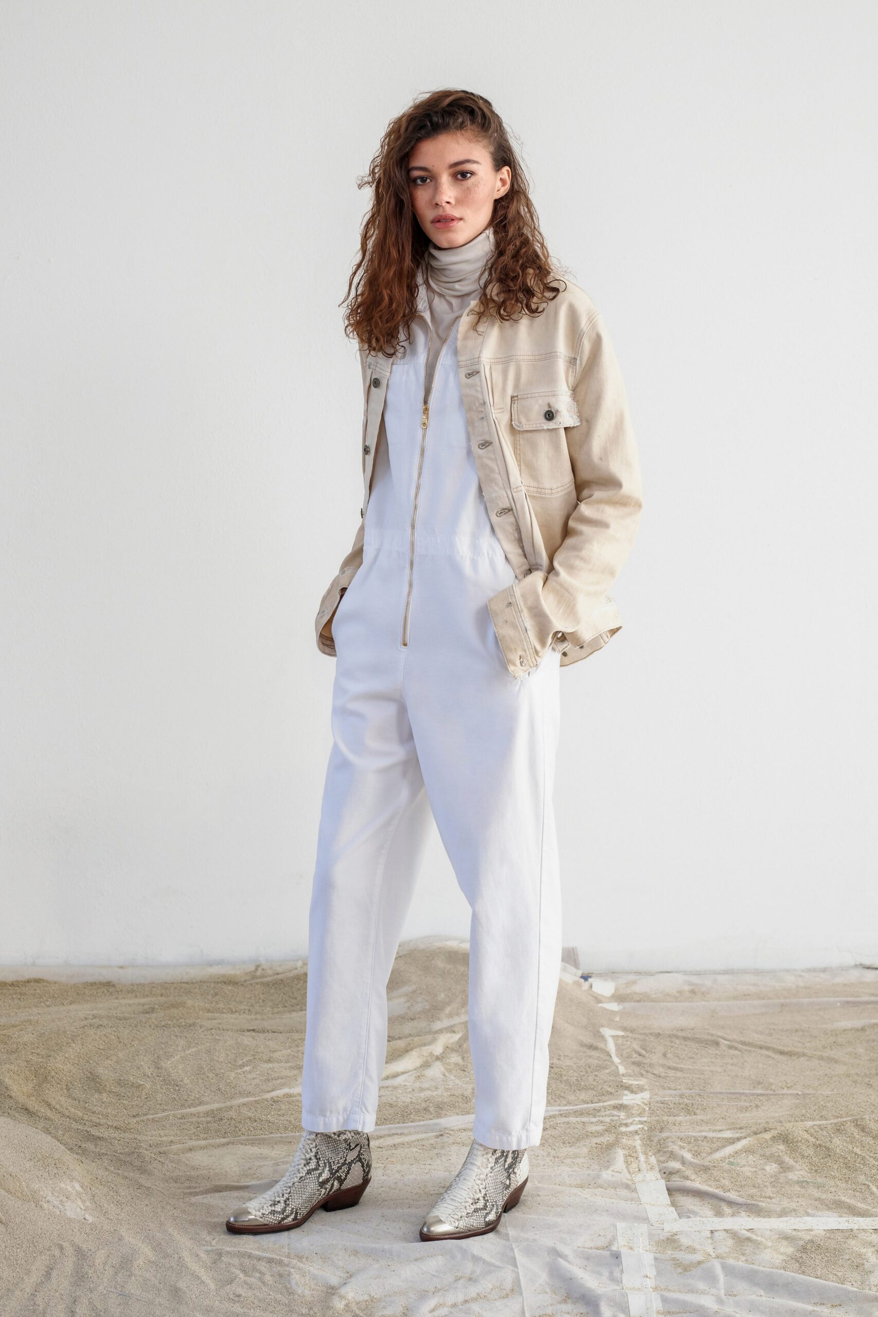 beige jacket white jumpsuit silver boots