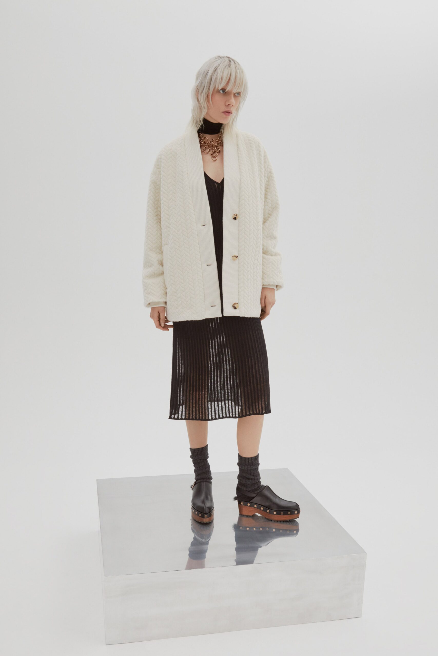 black pleated midi dress with oversized cardigan