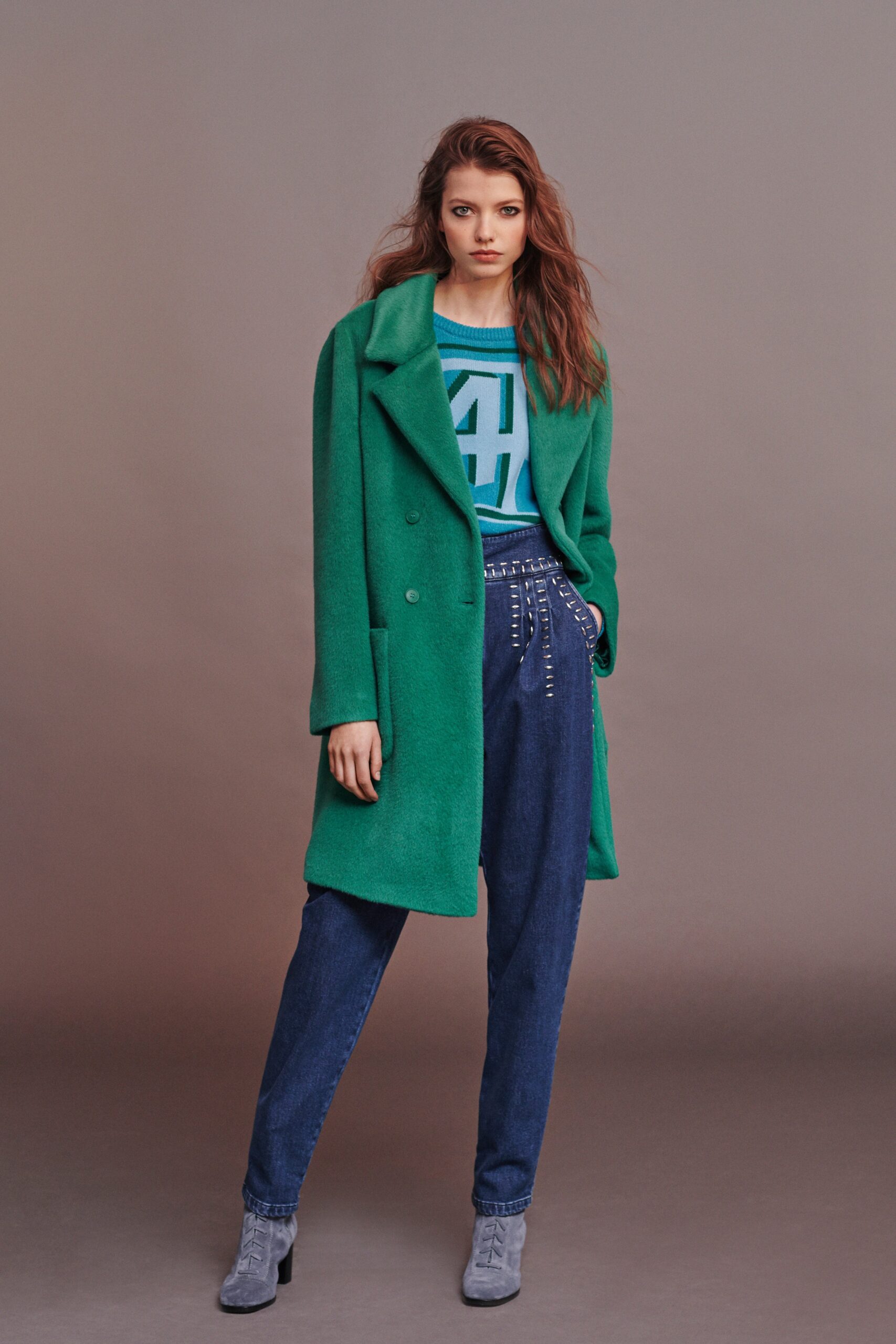 green wool coat with blue sweater