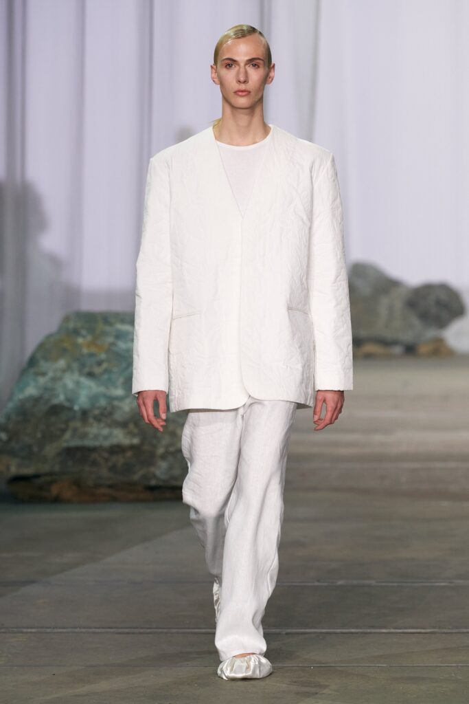 A relaxed white cotton jacket paired with straight-leg pants for a modern look.