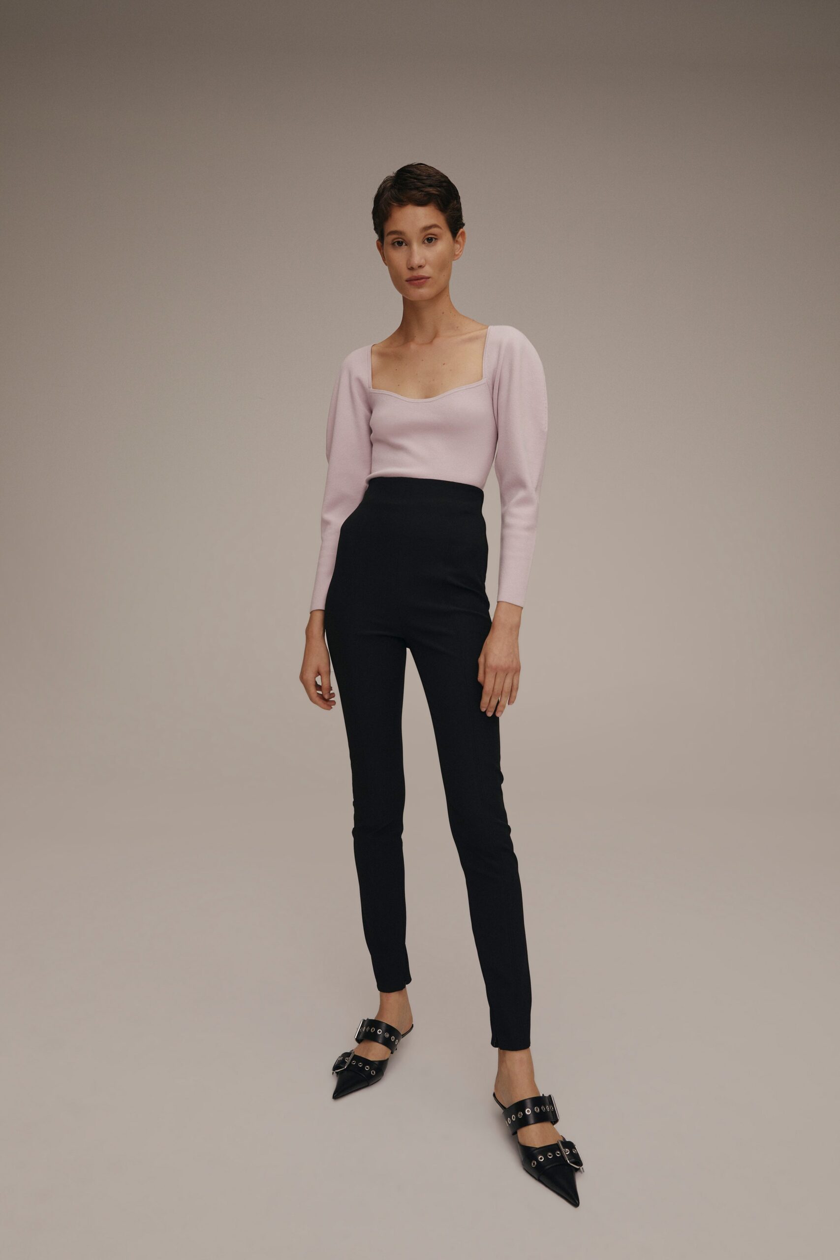 pink fitted top with black pants
