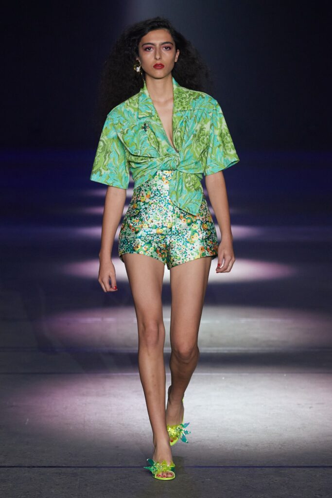 A fitted green floral shirt with short sleeves paired with matching shorts.