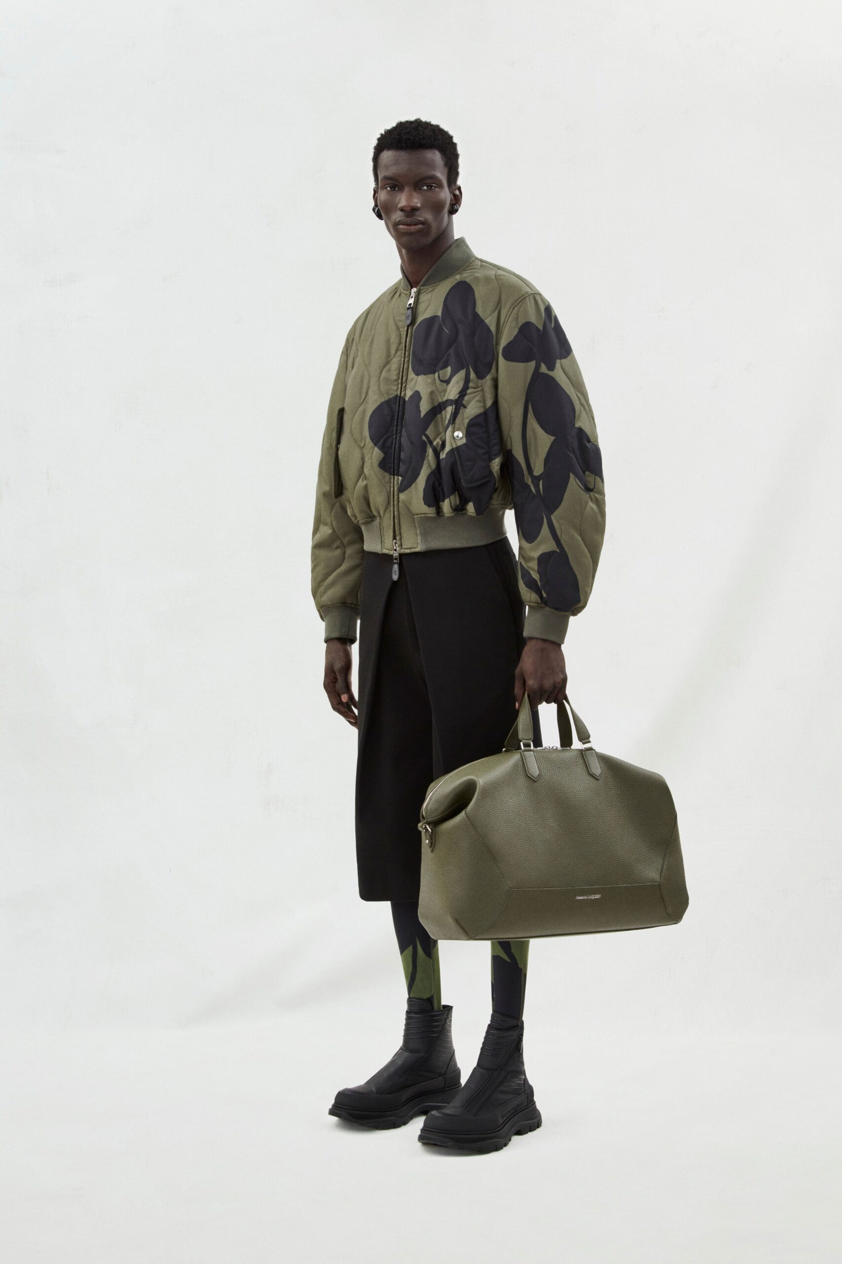 green quilted jacket with black pants
