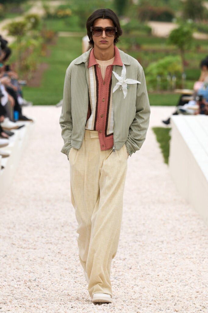 A relaxed green striped jacket paired with wide-leg beige pants for a stylish look.