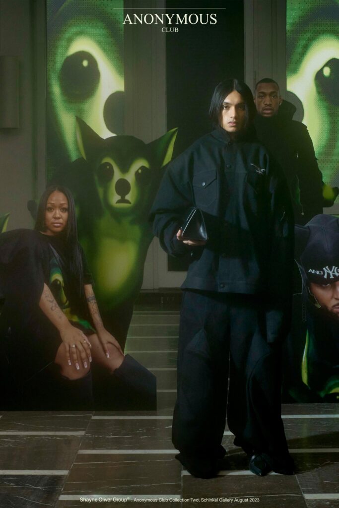 An oversized black jacket with long sleeves and matching pants, featuring a layered design.
