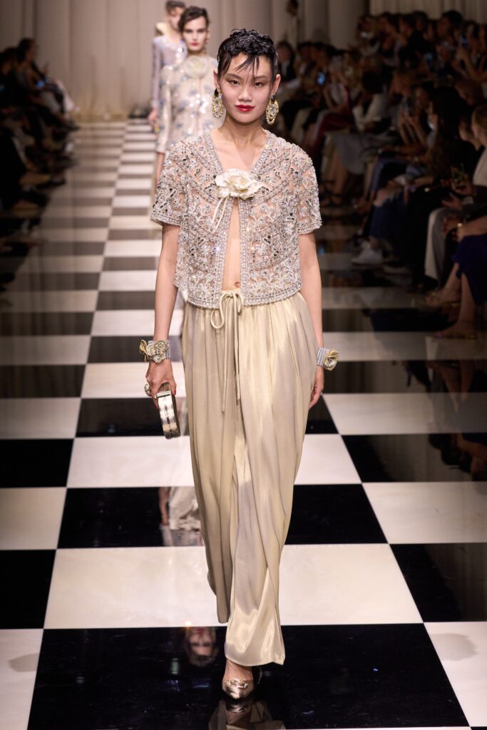 beige beaded top with ivory wide-leg pants