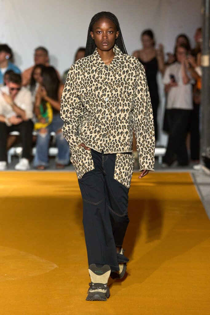 A relaxed-fit beige animal-print jacket paired with black pants, perfect for a casual look.