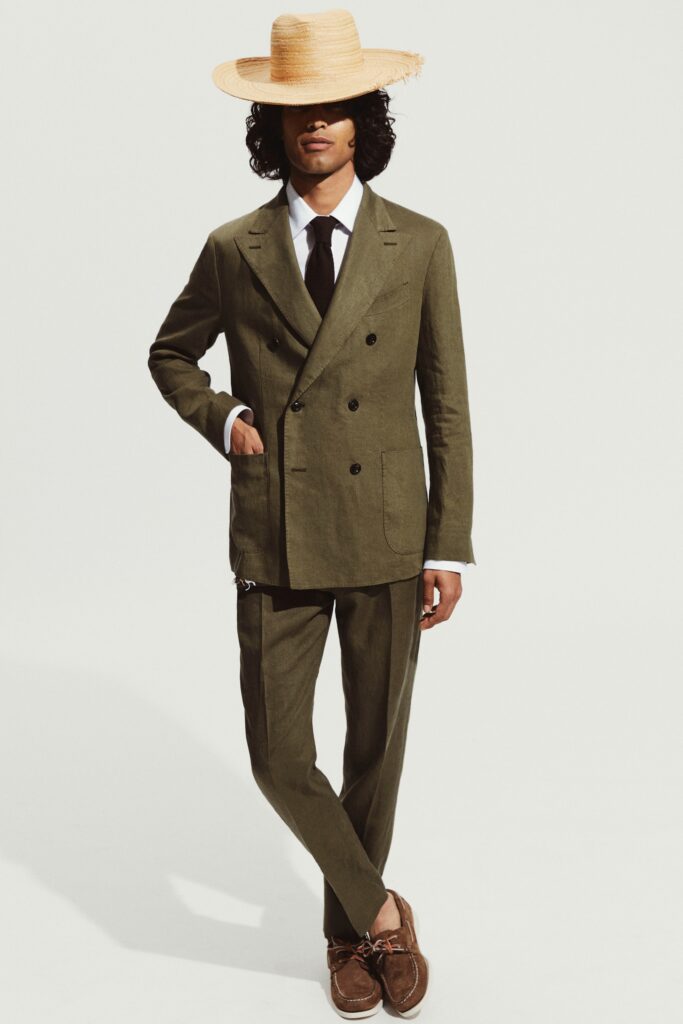 A tailored green linen suit with long sleeves and a double-breasted design.