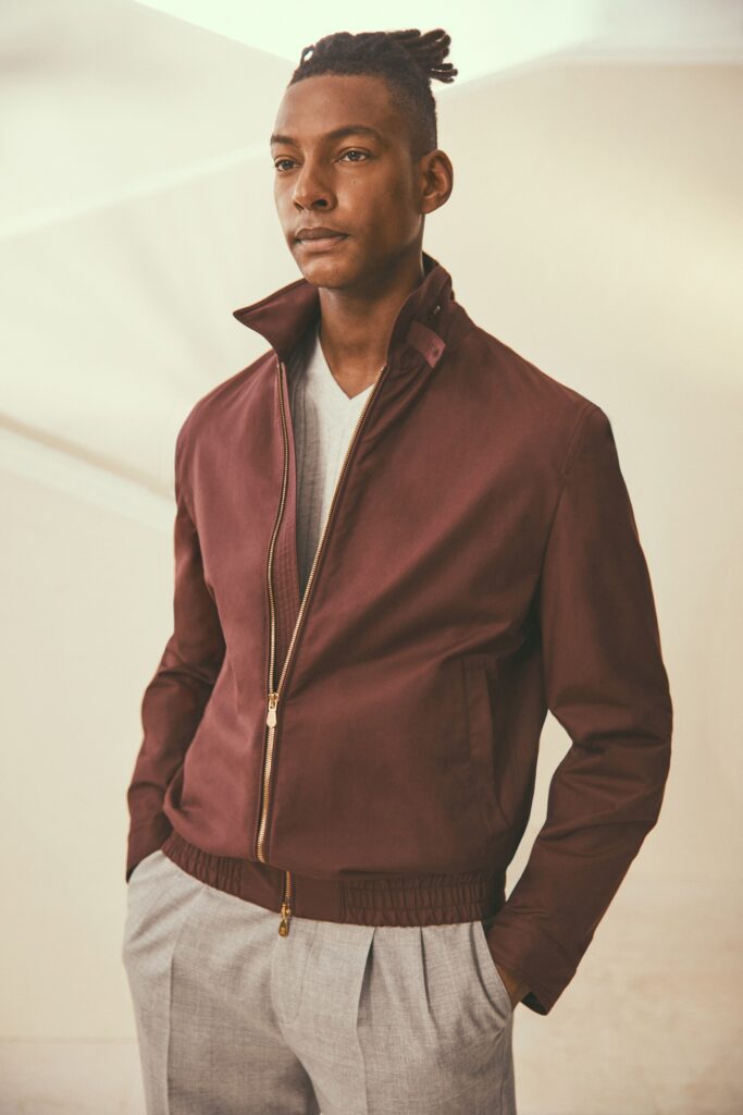 A fitted burgundy cotton jacket with a zippered front and collared design.