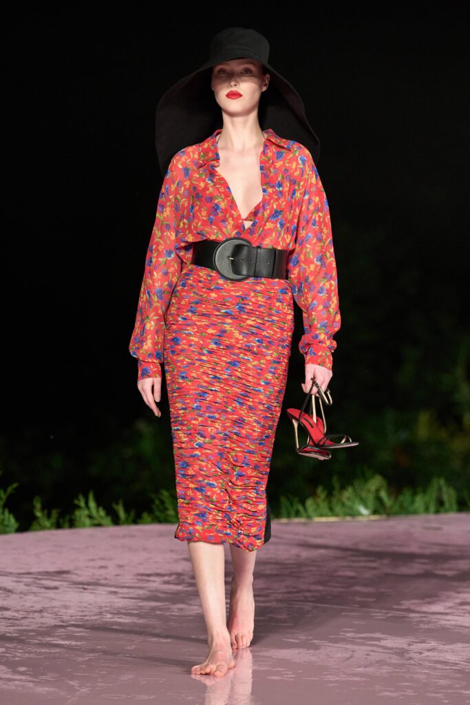 A fitted long-sleeve printed silk dress with a V-neckline and tiered design.