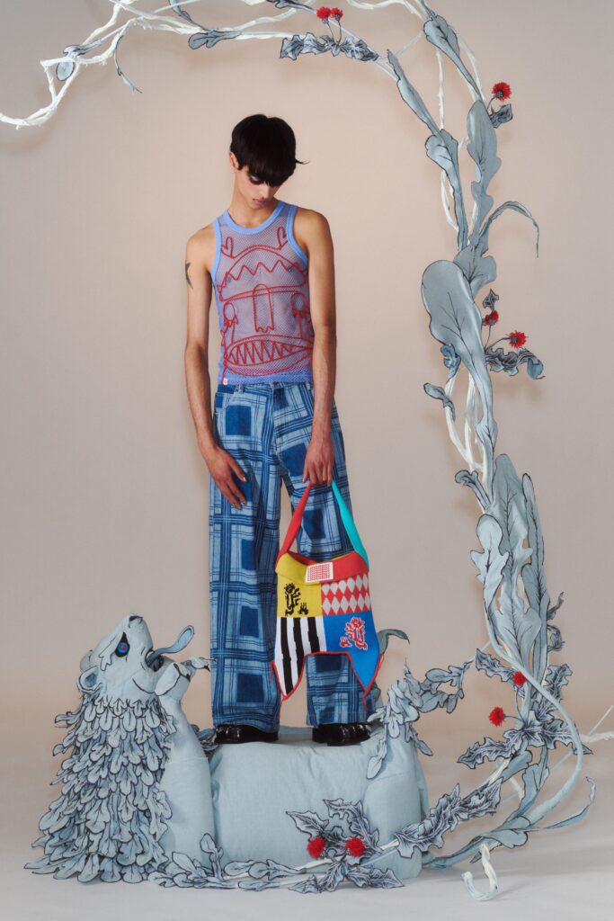 A relaxed-fit sleeveless printed blue cotton top paired with wide-leg pants.