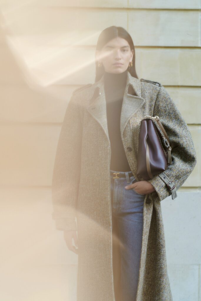 A relaxed gray wool coat paired with a high-neck top and buttoned details.
