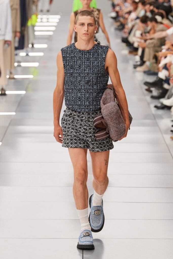 A fitted sleeveless blue printed top paired with stylish black shorts.